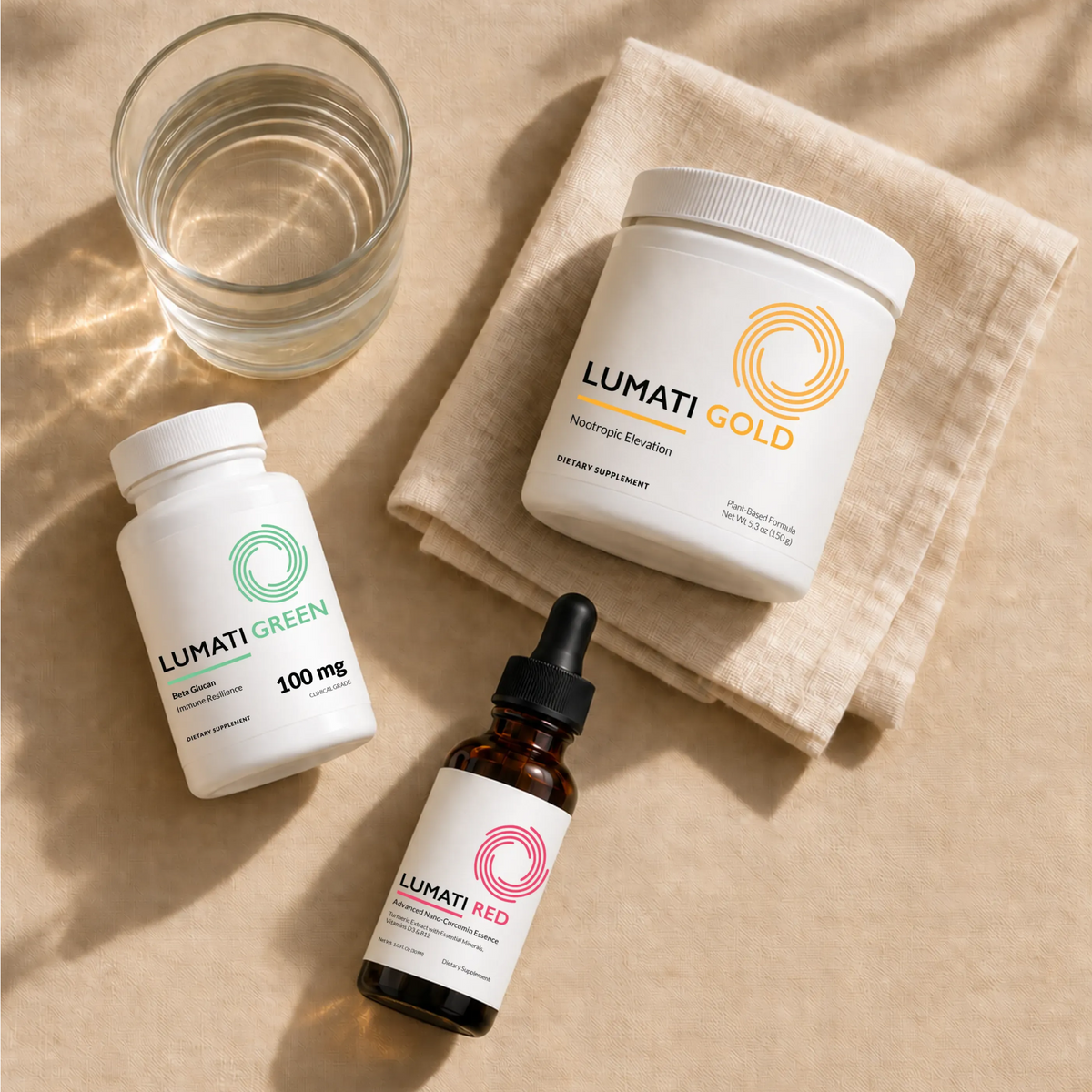 Lumati Gold powder tub, Lumati Green 100 mg capsule bottle, and Lumati Red dropper bottle on a beige linen napkin beside a glass of water in warm sunlight.